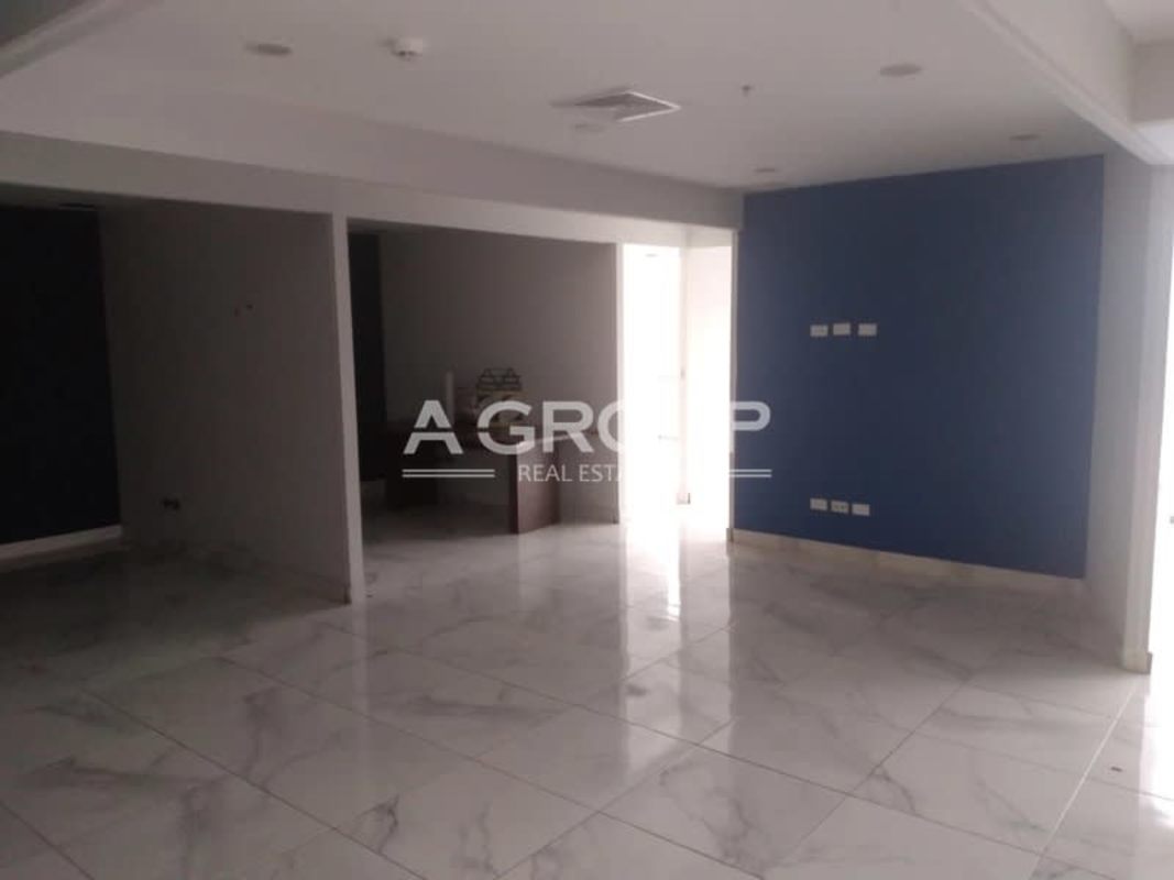 Open office area with marble flooring blue accent wall Financial Park Costa del Este