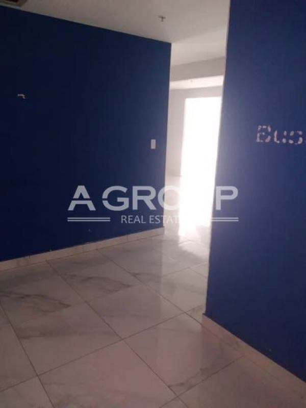 Entrance area with blue accent wall and marble floors office building Costa del Este