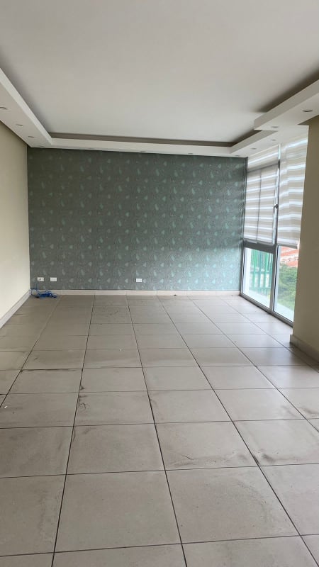 Modern empty living room with tiled floor and large floor-to-ceiling windows Condado del Rey Panama
