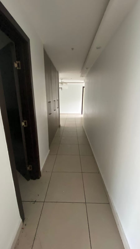 Long corridor with built-in wardrobe, white walls, tiled floors at PH 4H Panama