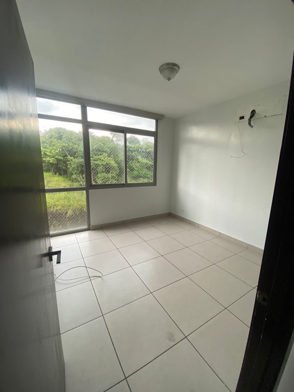 Spacious bedroom with white walls, large window and tiled floor PH 4H Condado del Rey