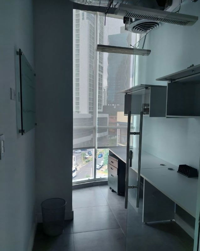 Modern office room with large window, built-in desk, glass board and cityscape in PH Molon Tower Panama