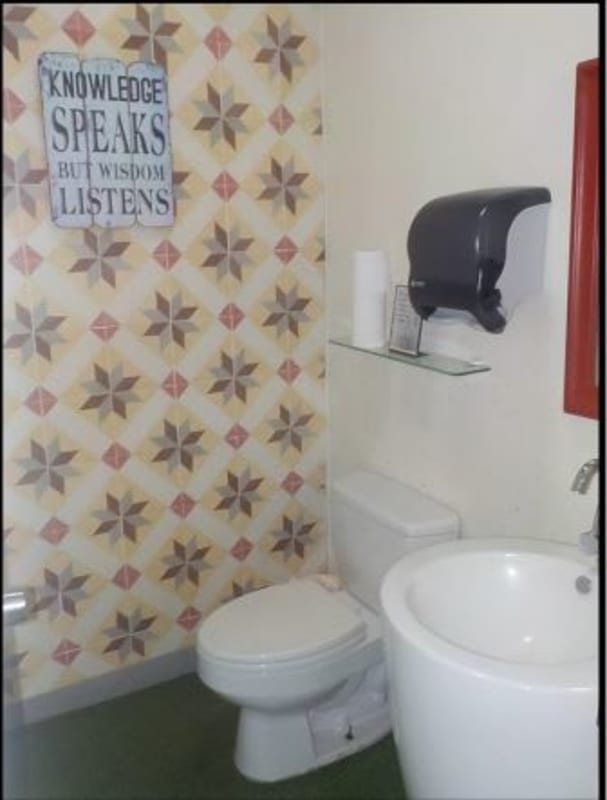 Commercial bathroom with decorative tile, pedestal sink and mirror PH Molon Tower Panama City
