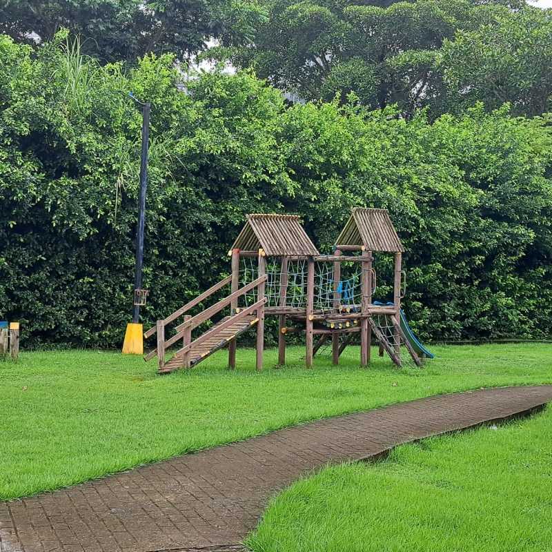 Children's playground with slide and wood structures in Mystic Village Don Bosco