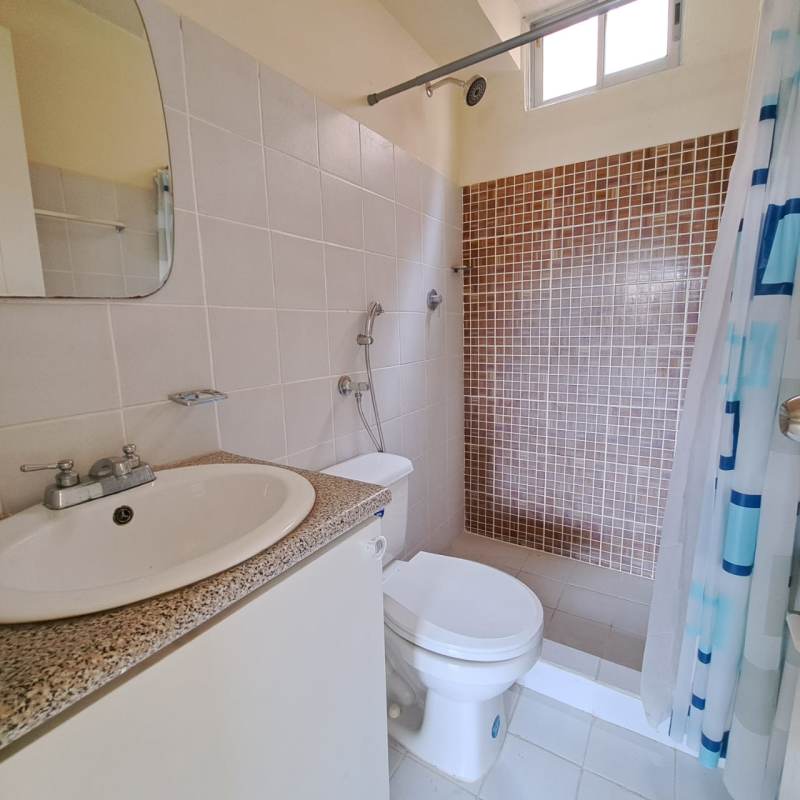 Bathroom with walk-in shower, mosaic tile wall, compact vanity in Don Bosco Panama