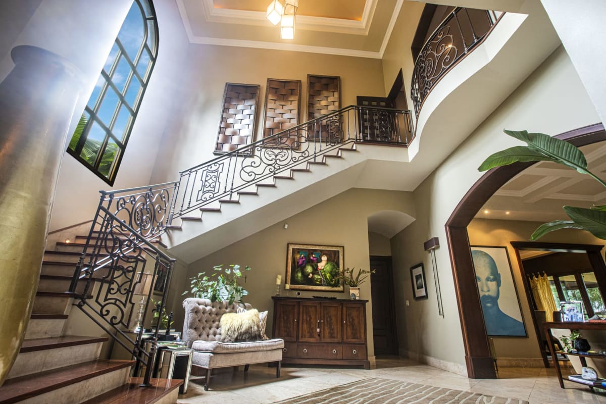 Spacious luxury living room with bar area, wood accents, and elegant seating in Balmoral Costa del Este Panama