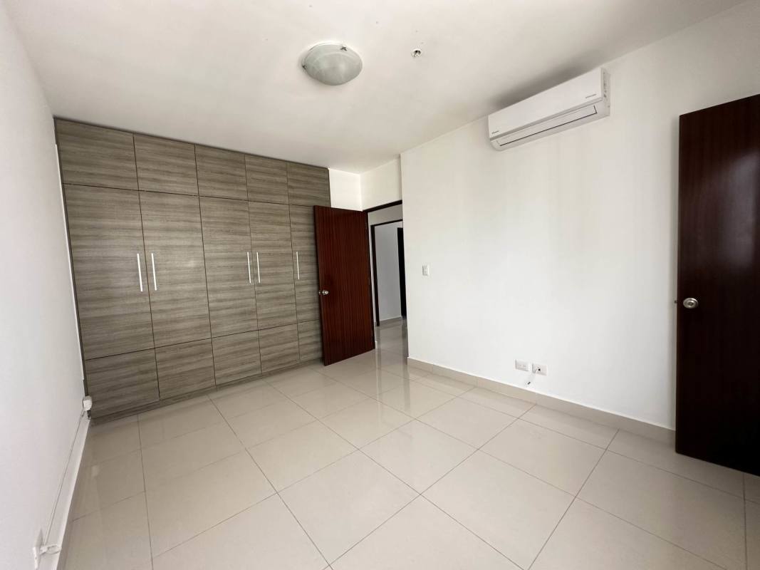 Condominium gym with large windows and modern equipment at PH Brisa Marina Panama