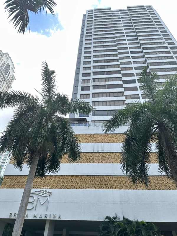 Modern high-rise exterior of PH Brisa Marina with oceanfront views and palm trees Costa del Este Panama