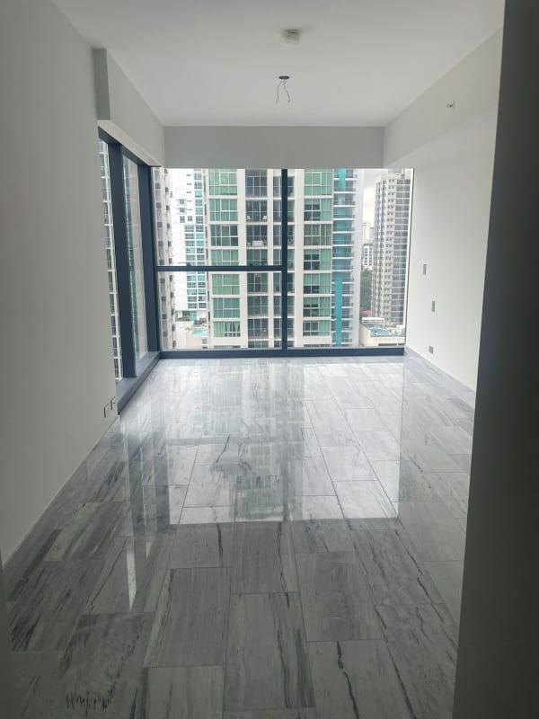 Spacious living room with marble floors and cityscape views at PH Nouvo Bella Vista