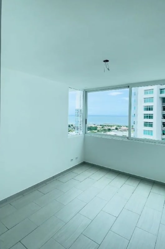 Spacious bedroom featuring ocean and city skyline view PH The Towers Residences Panama City
