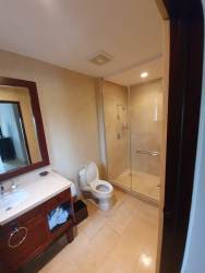 Contemporary bathroom with walk-in glass shower and vanity at Buenaventura Beach home Panama
