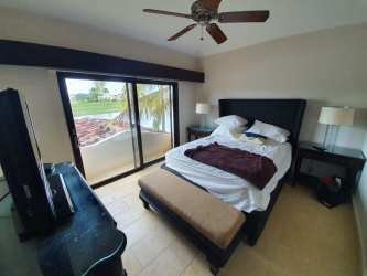 Master bedroom with garden and lagoon views, sliding glass doors at Buenaventura Villa Panama