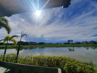 Shaded terrace overlooking lagoon and gardens at Buenaventura Villa Panama