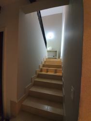 Interior staircase with tiled steps and metal railing at Buenaventura Villa Panama