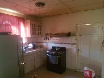 Cozy living room with floral furniture and large window in Don Esteban house for sale in Chitre