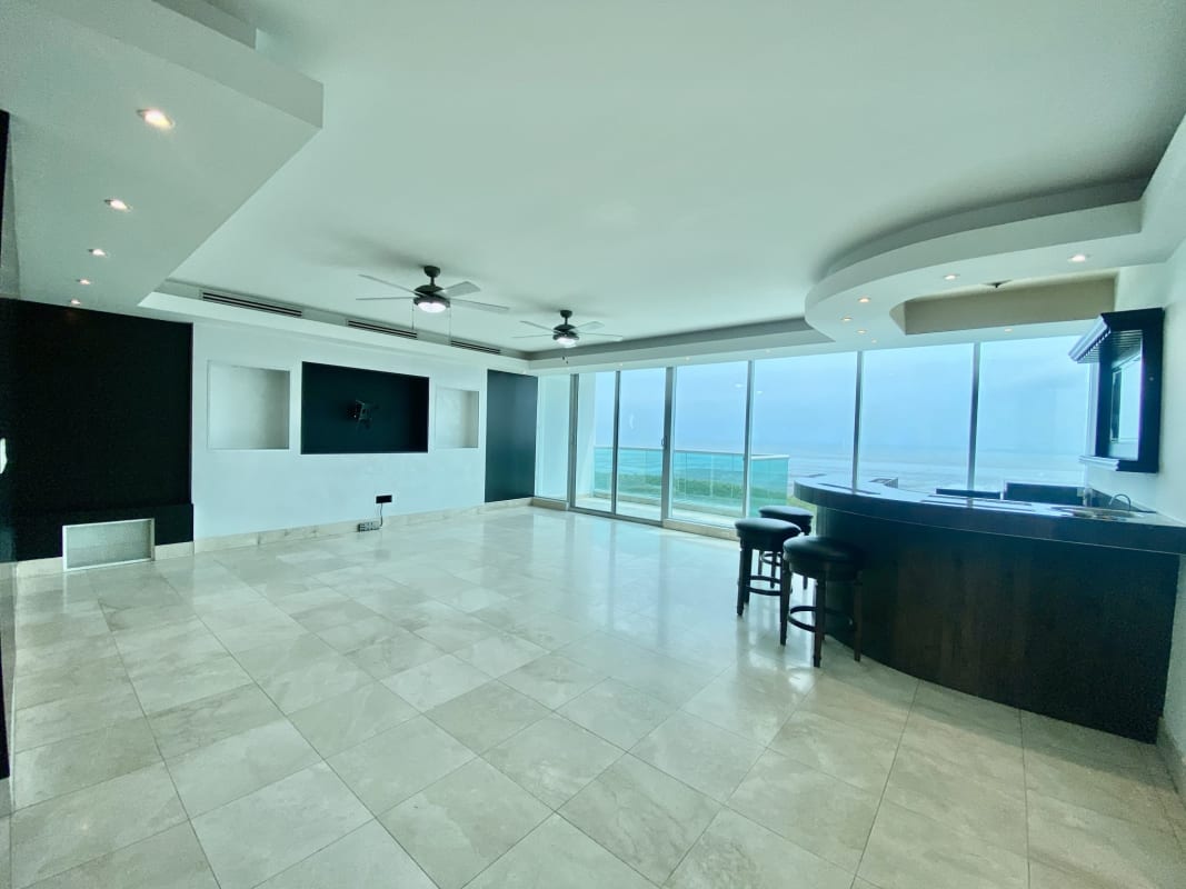 Bright living room with floor-to-ceiling ocean view windows in PH Ocean Two Costa del Este Panama