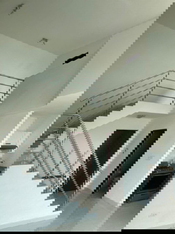 Interior mezzanine with foliage accent wall and staircase in Park Loft Panama