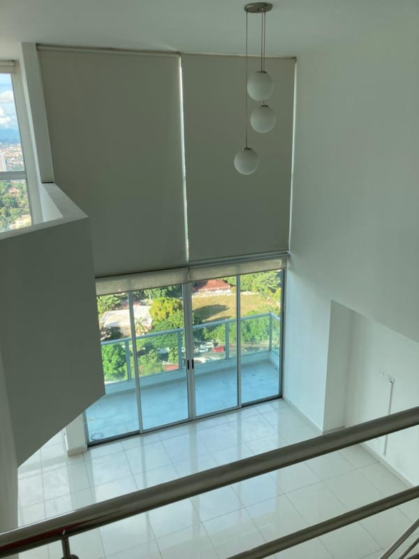 Spacious living room double height windows balcony Park Loft Panama City