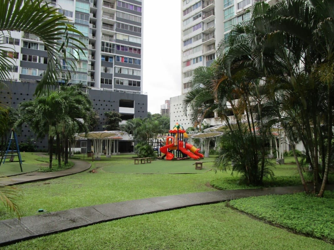 Landscaped courtyard with children’s playground, gardens at PH Parques del Este Panama City