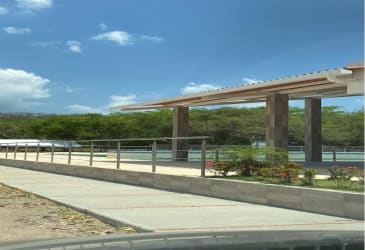 Covered pedestrian path with landscaping and mountain views in Cermeño Capira Panama