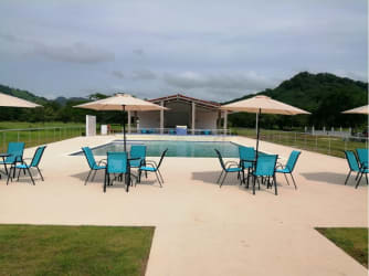 Outdoor poolside area with tables umbrellas mountain views Cermeño Capira Panama