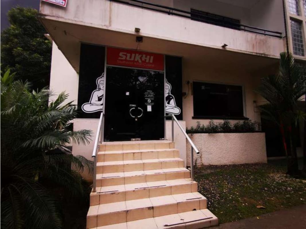 Street level view Southeast Asian restaurant and exterior stair with tropical plants at PH America Obarrio Panama