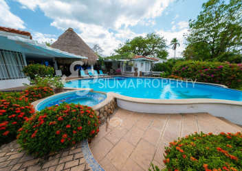 Rustic Mediterranean kitchen featuring blue tile countertops, wood cabinets at Punta Barco Villa Panama