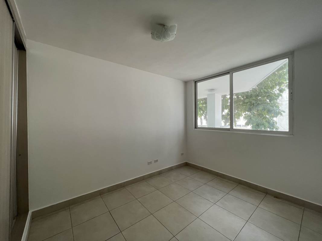 Bedroom with sliding glass door to balcony and skyline view PH El Mare Edison Park Panama