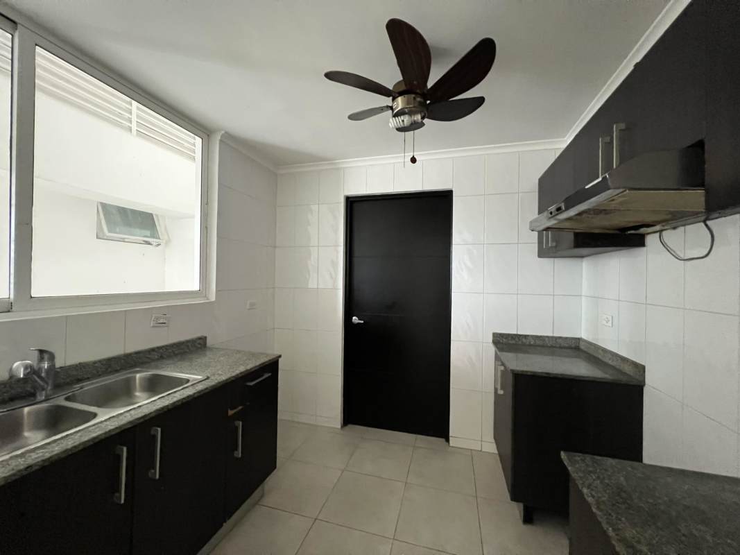 Modern kitchen in PH El Mare with black cabinets, granite counters and stainless sink Panama