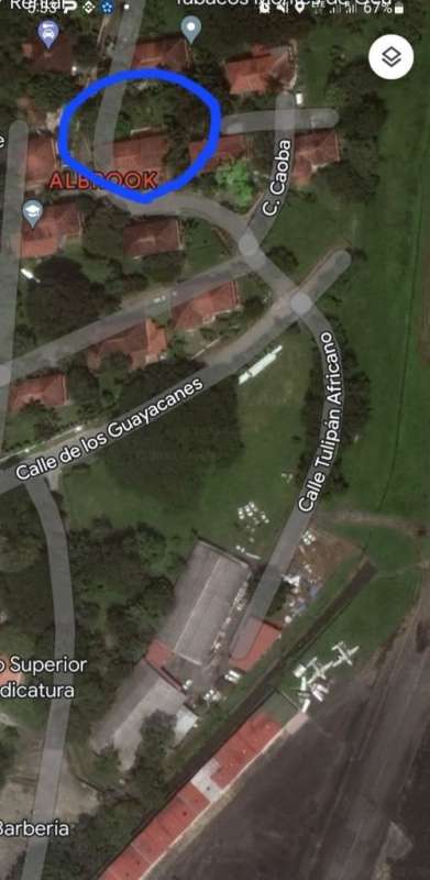 Private gated driveway in Albrook residence compound with parking area and greenery