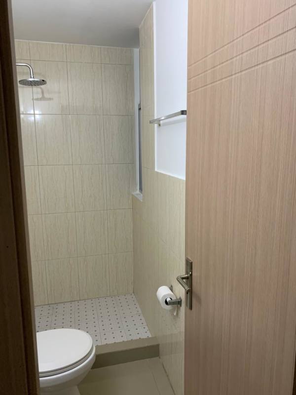 Modern living room with large windows overlooking city lights PH River One Panama