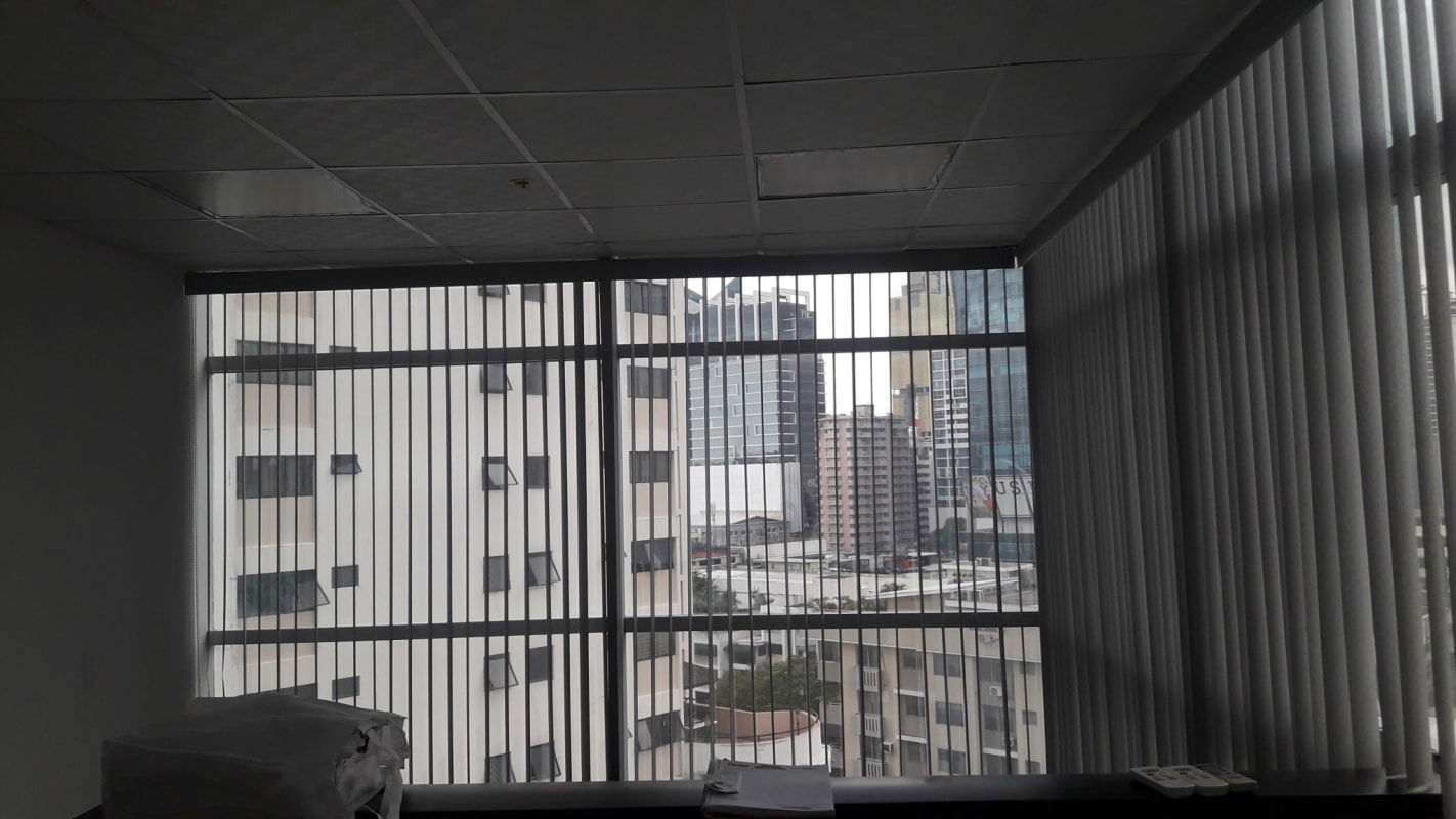 Office interior with large vertical windows overlooking Panama City skyline PH Obarrio 60
