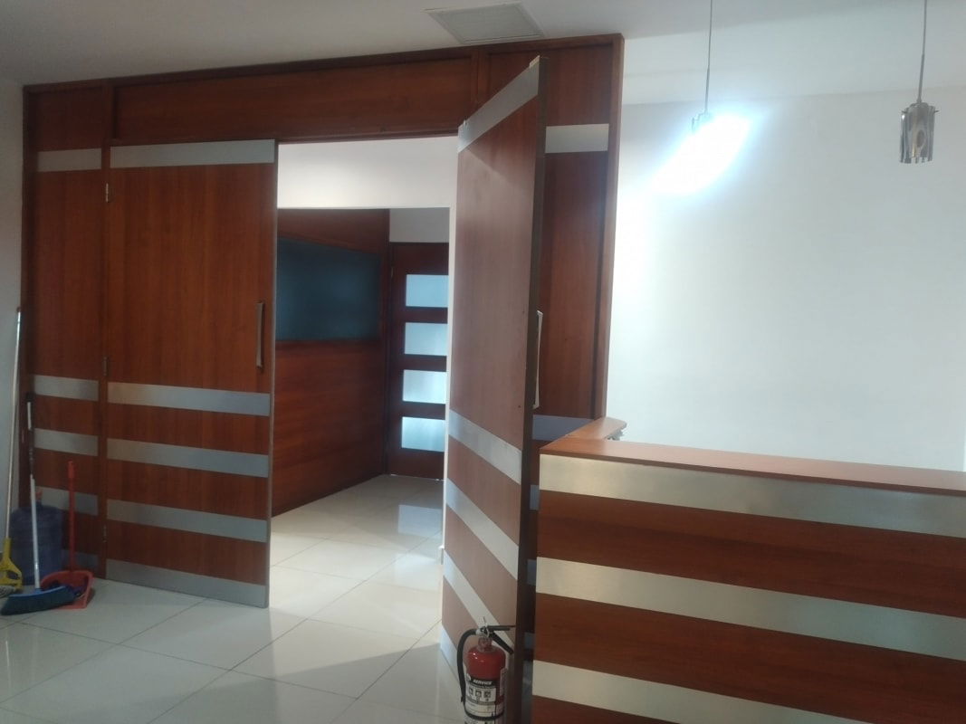 Modern reception with wooden sliding doors metallic accents at PH Brasil 405 Obarrio Panama