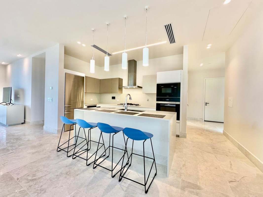 Modern kitchen with island seating and stainless appliances PH Casa del Mar Ocean Reef Panama