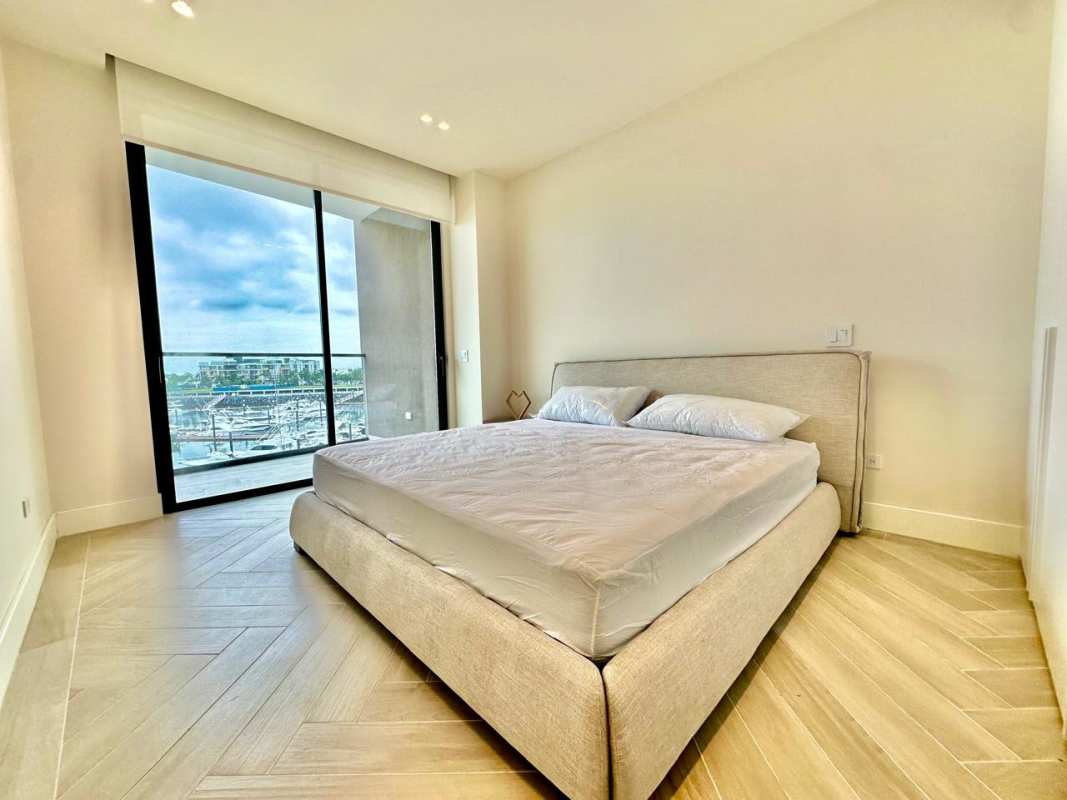 Luxury master bedroom with marina views and floor-to-ceiling windows in PH Casa del Mar Ocean Reef Islands Panama