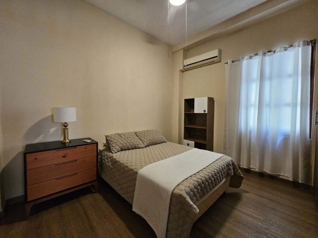 Furnished bedroom with wood floors, large windows, AC, ceiling fan in PH Casa del Mar Casco Viejo Panama