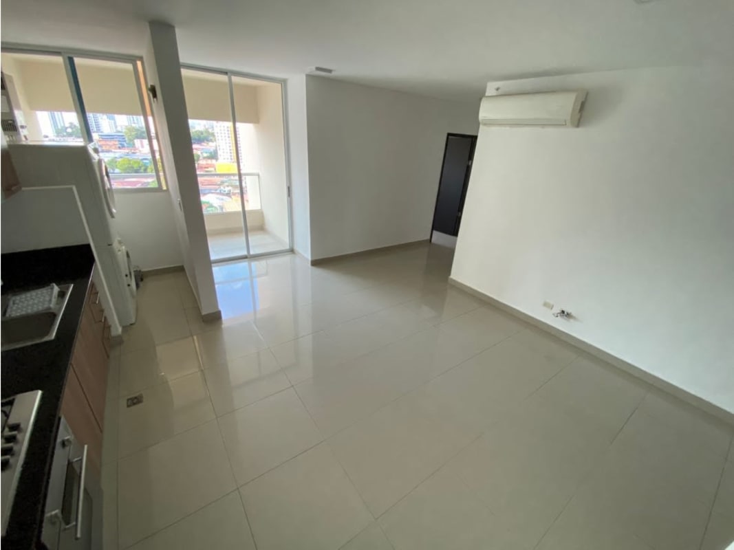 Open-plan kitchen with dining area, wood cabinets and granite countertop in PH Diamond Tower San Francisco Panama