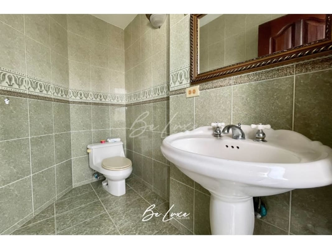Bathroom with granite countertop, shower, and traditional tile design in PH Buganvilla Panama City