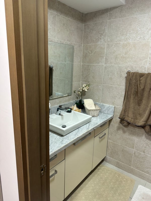 Bathroom with glass shower, modern fixtures, neutral tiles in PH Park City Panama