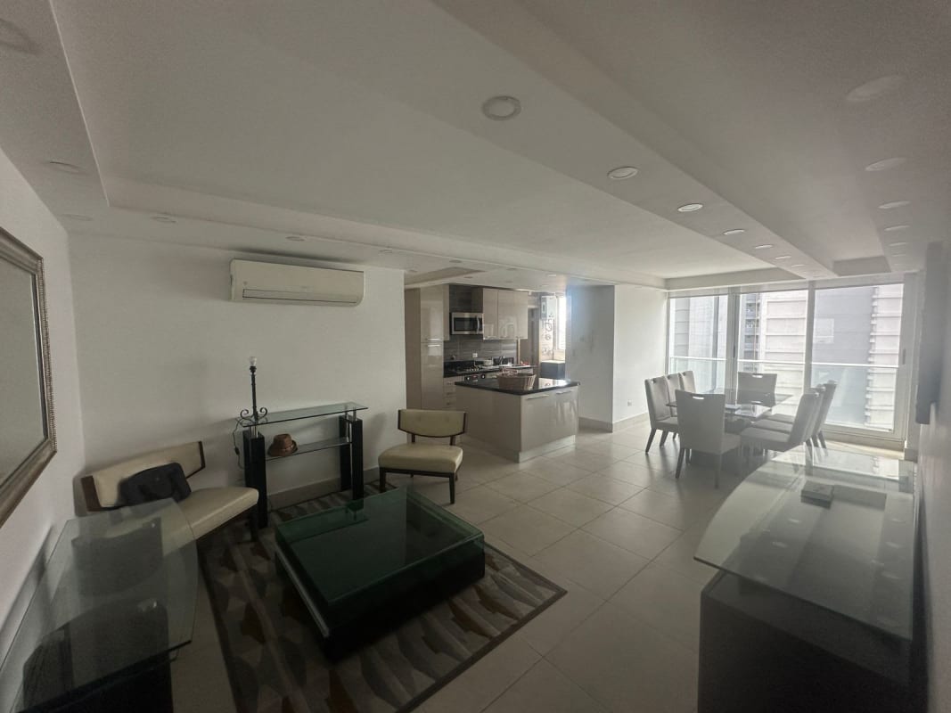Open living dining area with kitchen island, modern décor, and city views at PH Park City Obarrio Panama