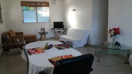 Bright open living and dining room with garden views in Cabuya Chame country property