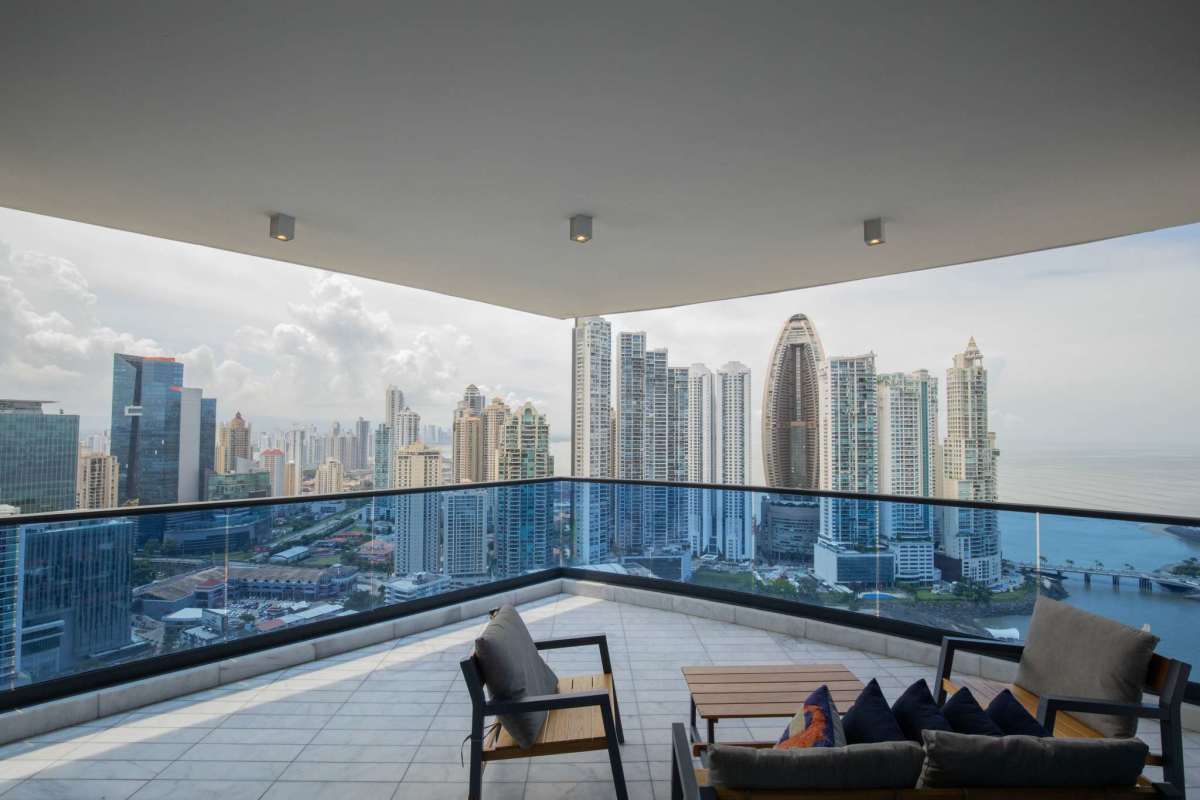 Modern marble living room with floor-to-ceiling windows and bay views in luxury penthouse