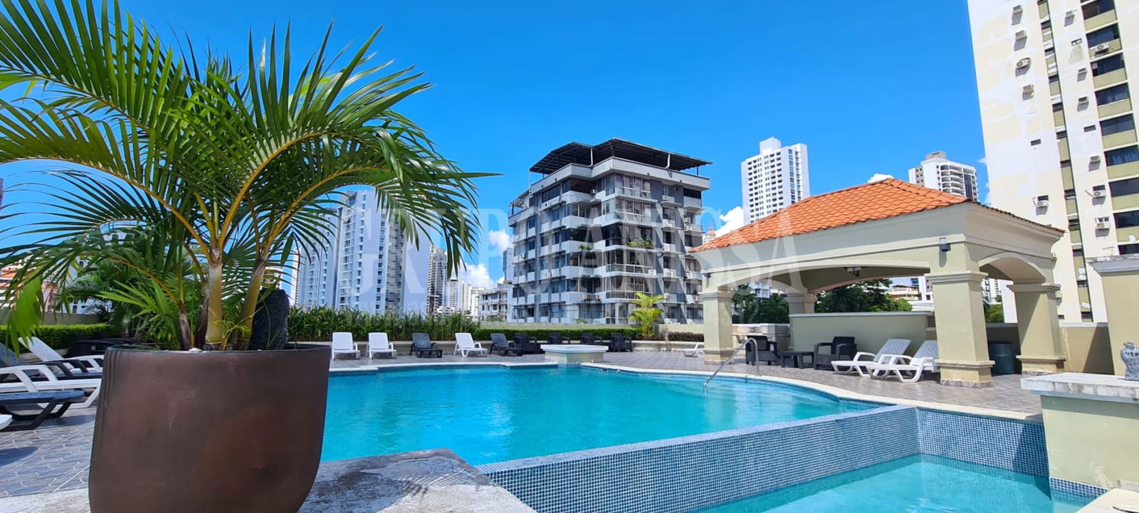 Outdoor pool with lounge chairs covered seating landscaping El Cangrejo Panama