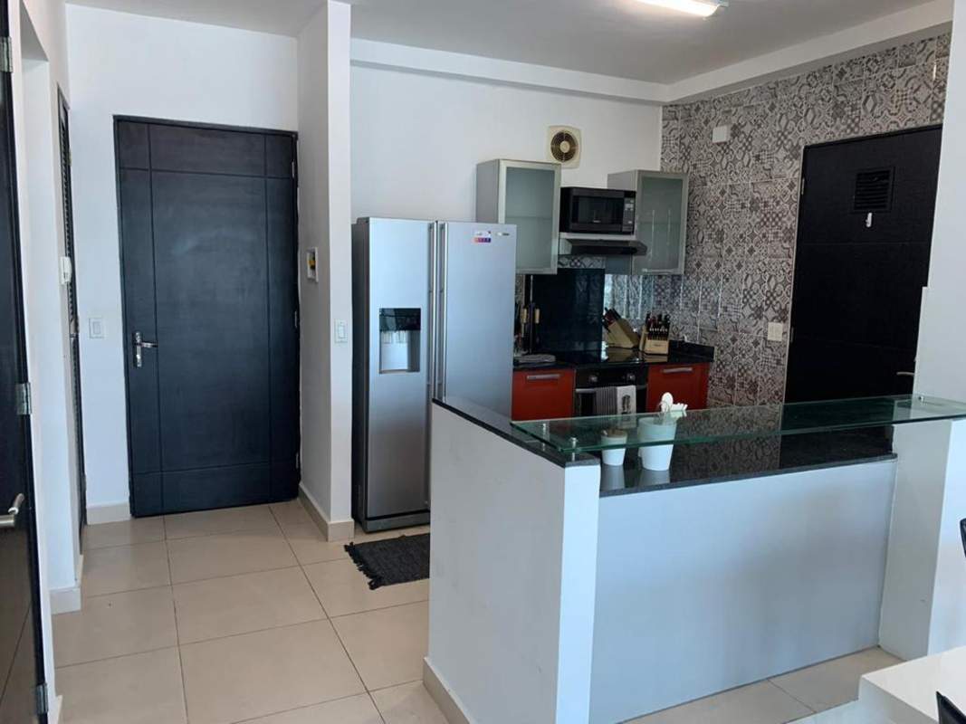 Open plan living and dining room with floor to ceiling glass to balcony with waterfront views at PH Destiny