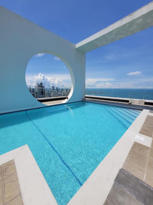 Indoor swimming pool area with panoramic Panama City skyline and ocean views in PH Destiny