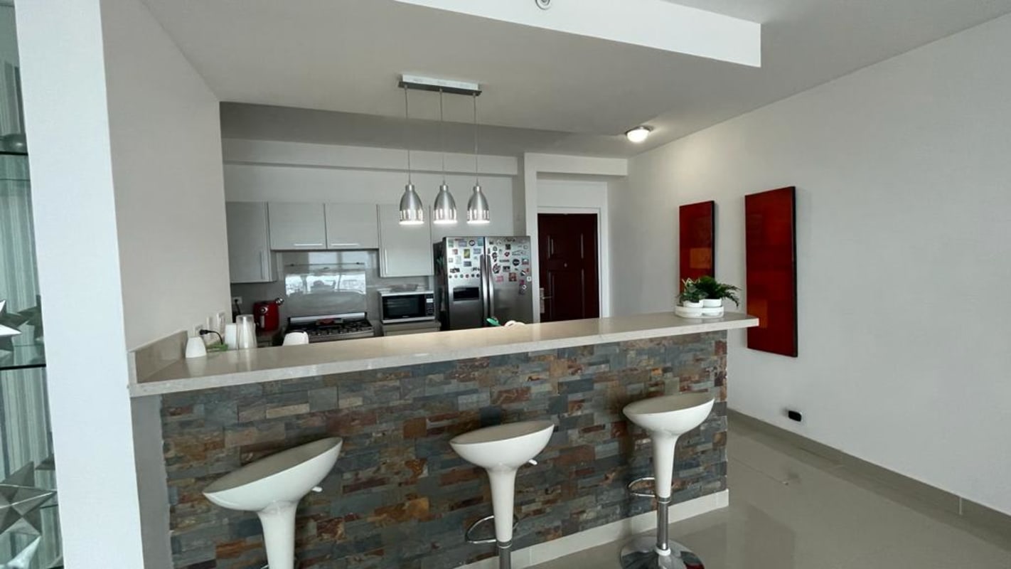 Modern open kitchen with granite countertops and breakfast bar in PH Top Tower Costa del Este Panama City