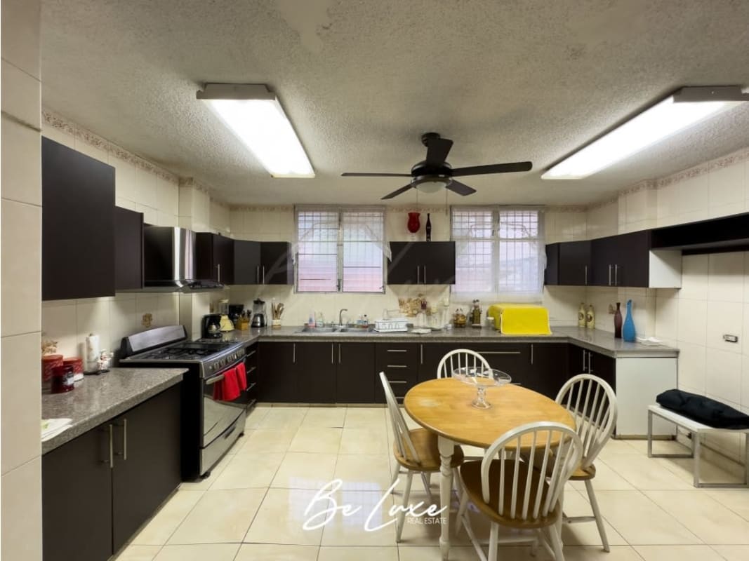 Spacious kitchen with dining area, modern cabinetry and appliances in La Loma residence Panama City