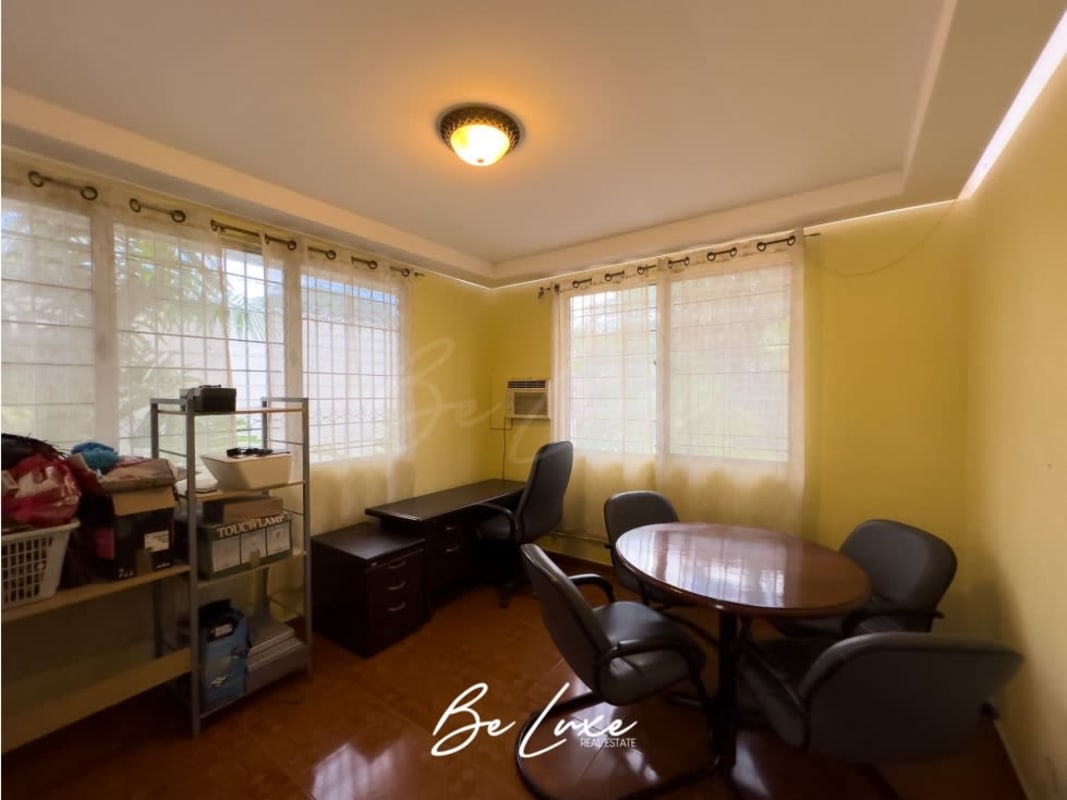 Bright home office with large windows overlooking garden in luxury house La Loma Panama City