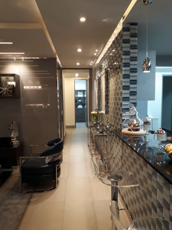 Modern kitchen with granite countertop and dining area Panama City condo