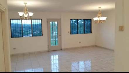 Open dining and living room with plenty of light in family house rental Chiriquí